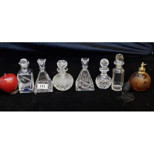 111 - Seven perfume bottles including crystal examples from Dublin and Galway Crystal. Along with an orang... 