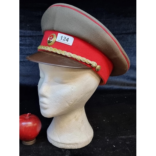 124 - An original Hungarian People's Army military peaked cap featuring an emblem and a golden rope.