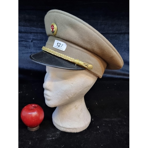 127 - A vintage Hungarian People's Army military peaked cap featuring an emblem and a golden rope.