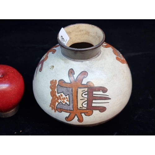 148 - An unusual vintage South American terracotta vase with a round base and an abstract figural design. ... 