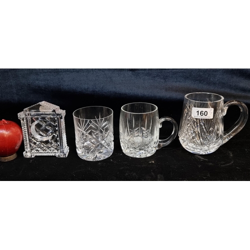 160 - Four crystal and glass items including two Waterford Crystal tankard and Waterford crystal mantle cl... 