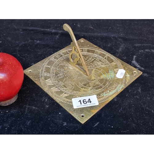 164 - A brass sun dial with a detailed engraving and mountable base.