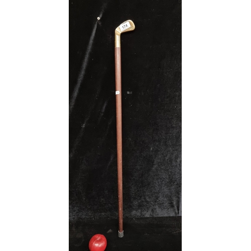 174 - A handsome walking stick with a brass handle in the form of a golf club head.