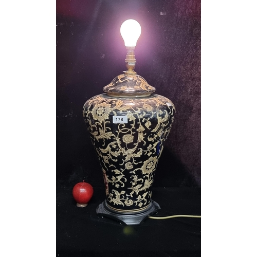 178 - A fabulous very large ceramic table lamp with floral motifs in rich tones of navy and cream.