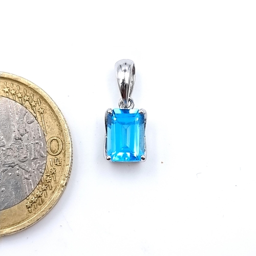 18 - A fabulous square cut Ocean Blue Topaz pendant, set with 9 carat White Gold.