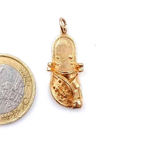 20 - A pretty gold charm, in the form of an oriental slipper. Unmarked. Weight: 3.08 grams. (probably 9ct... 