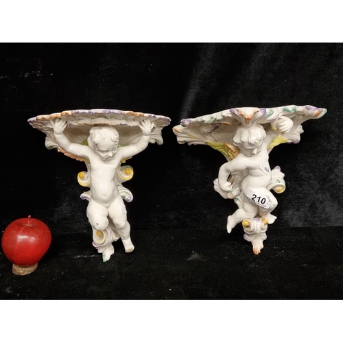 210 - A beautiful pair of hand painted Italian vintage cherub wall sconces. In good condition.