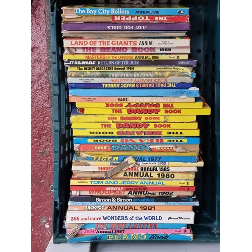 216 - A large collection of vintage annuals including examples from The Beano and The Dandy.