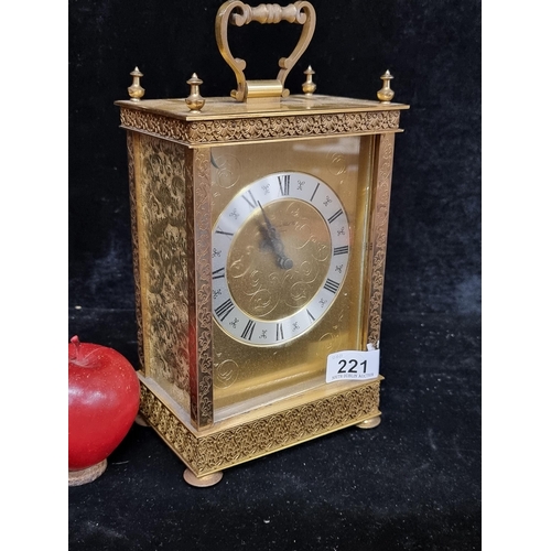 221 - A heavy, good quality and highly ornate carriage clock from London Clock Co. Housed in a brass case ... 