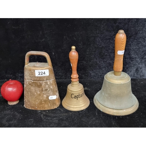 224 - Three vintage bells including a 19th century brass cow bell and two antique  school bells, one marke... 