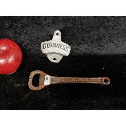 234 - Two interesting pub related items comprising of two cast metal Guinness botte openers.