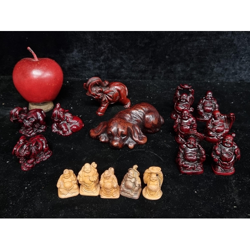 257 - A collection of over twenty figures in a burgundy finish including an elephant, dog and buddhas.