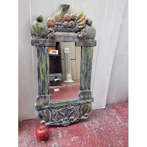 260 - A carved wood hall mirror with fruit and scroll foliate details. Features a rustic rope detail to ha... 