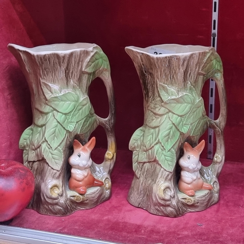 303 - A pair of vases in the form of tree stumps with cheerful squirrels, made by Withernsea Eastgate Pott... 