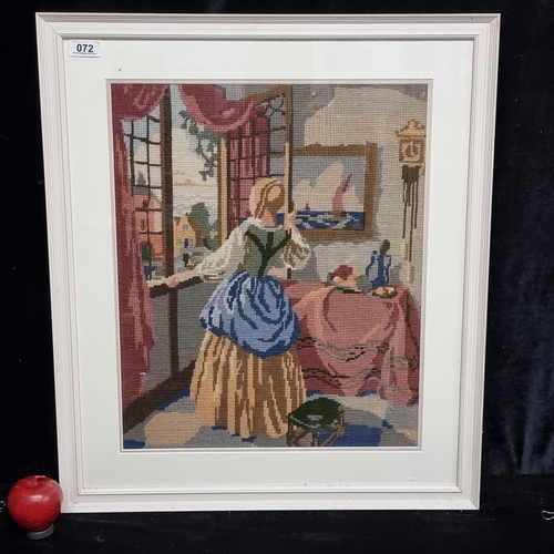 72 - A lovely large vintage cross stitch work featuring an elegant lady gazing out a window. Housed in a ... 