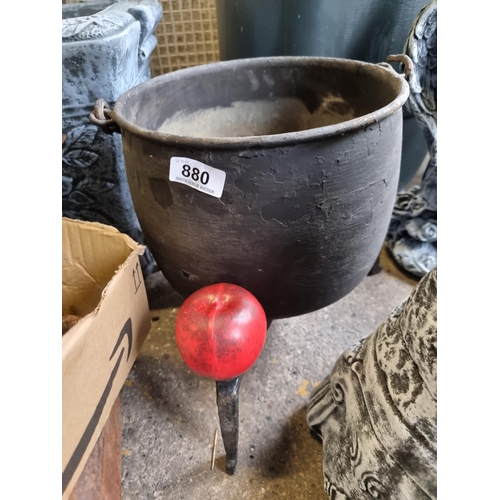 880 - A vintage metal cauldron with a handle. Accompanied by a tripod stand. Spooky time soon.