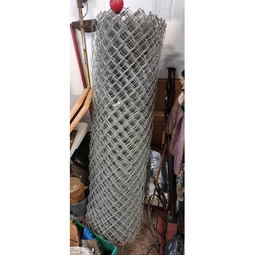 892 - A large roll of link mesh fencing. Approx 150cm tall