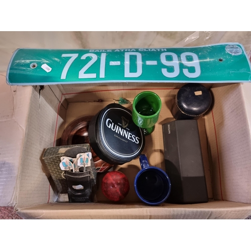 894 - A mixed lot of items including a Guinness branded CD travel holder, a Leinster rugby mug etc