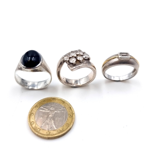 901 - A collection of three sterling silver rings, each featuring sparkling gem stone settings. Ring sizes... 