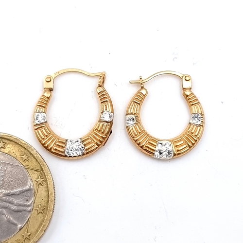 905 - A pretty pair of 9ct gold gem stone hooped earrings. Marked 375