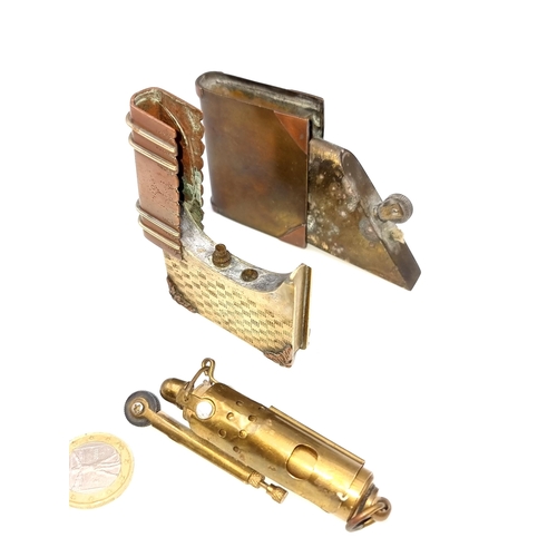 958 - Three vintage lighters, including a brass example in the form of a whistle, along with two brass and... 