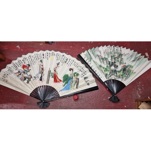 201 - A fabulous pair of oversized hand painted Chinese fans. Feature a traditional landscape scene along ... 