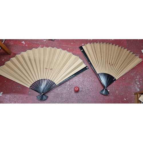 201 - A fabulous pair of oversized hand painted Chinese fans. Feature a traditional landscape scene along ... 