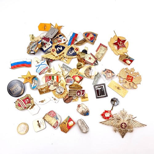 907 - A large collection of vintage pins and badges, with many Russian and USSR examples.