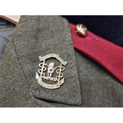 142 - A vintage Irish military jacket dating to 1984. With brass buttons, emblems and sawn-on patches.