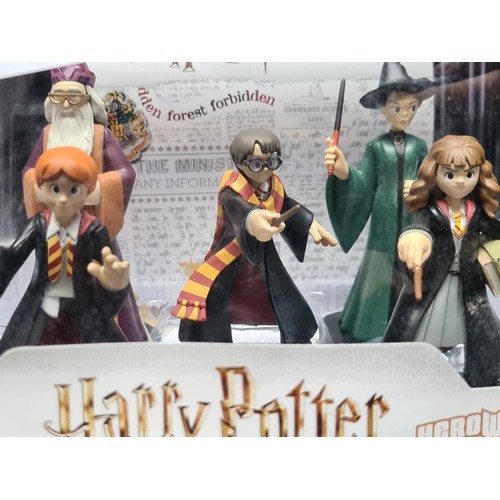 203 - A brand new boxed selection of Funko Harry Potter collectible figures including Ron Weasley, Hermion... 