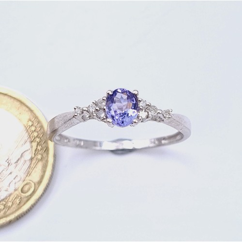 10 - Star Lot : An unusual 9 carat white gold Tanzanite stone ring, set with sparkling White Sapphires du... 