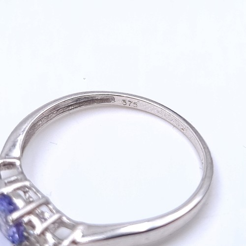 10 - Star Lot : An unusual 9 carat white gold Tanzanite stone ring, set with sparkling White Sapphires du... 