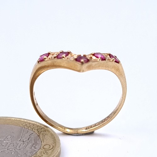 11 - Star Lot : A fine example of a Wish Bone 9 carat gold ring, featuring an array of Diamonds and Rubie... 