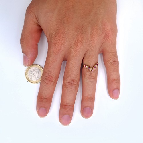 11 - Star Lot : A fine example of a Wish Bone 9 carat gold ring, featuring an array of Diamonds and Rubie... 