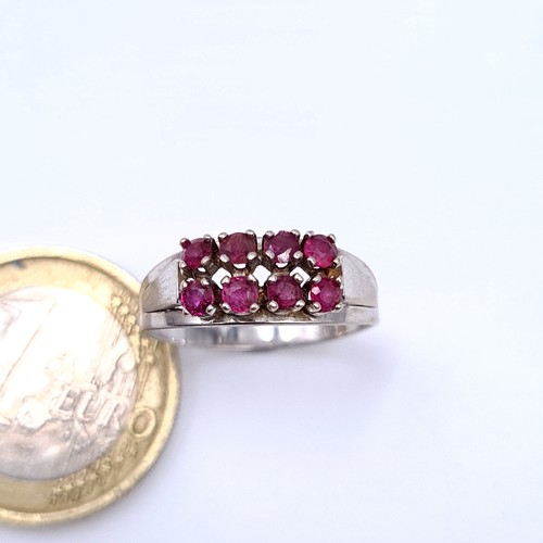 14 - Star Lot : A generous eight stone 14 carat White Gold Ruby ring, set with an array of Rubies and a w... 