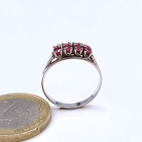 14 - Star Lot : A generous eight stone 14 carat White Gold Ruby ring, set with an array of Rubies and a w... 