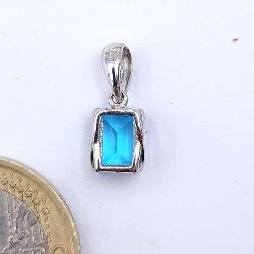 18 - A fabulous square cut Ocean Blue Topaz pendant, set with 9 carat White Gold.