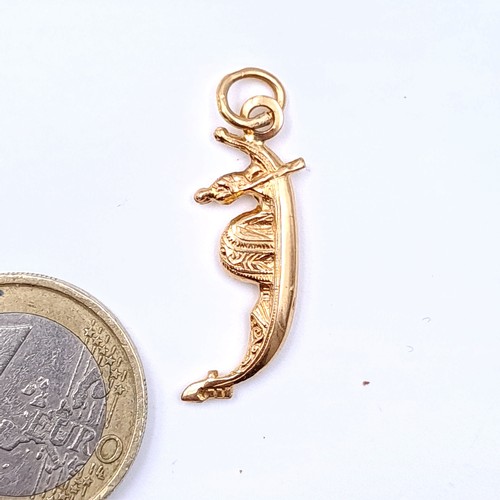 19 - An intricately formed 9 carat gold charm, in the form of a Gondola. Weight: 1.3 grams.