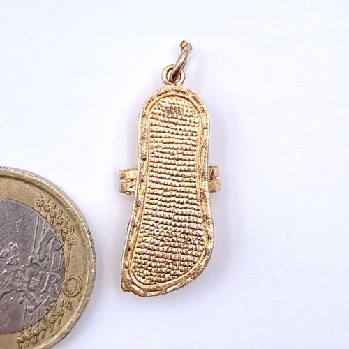 20 - A pretty gold charm, in the form of an oriental slipper. Unmarked. Weight: 3.08 grams. (probably 9ct... 