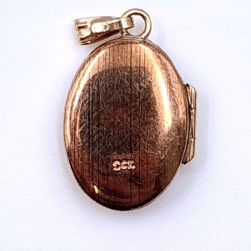 22 - Two items, including a 9 carat gold hinged locket, set with incised floral detail. Together with a 1... 