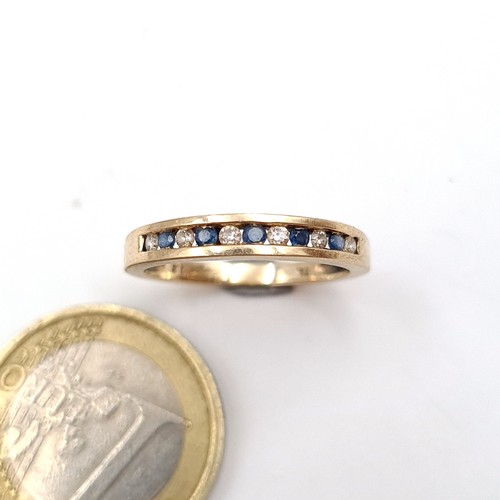 48 - Star Lot : A fabulous example of a Sapphire and Diamond channel cut half eternity 9 carat gold ring.... 