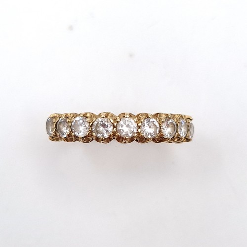 52 - A beautiful gem set 9 carat gold half eternity ring. Ring size: O. Weight: 2.77 grams.