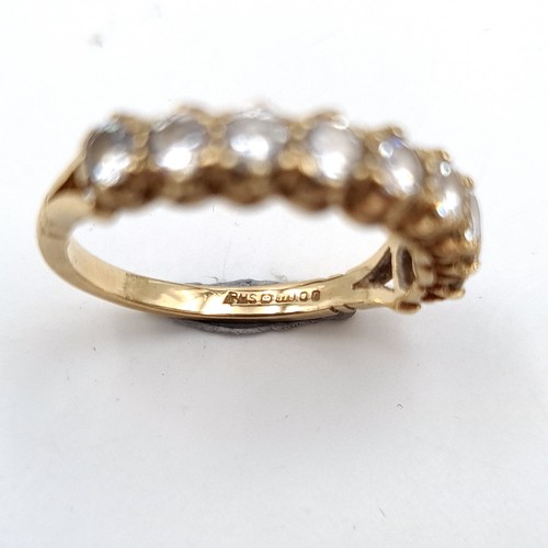 52 - A beautiful gem set 9 carat gold half eternity ring. Ring size: O. Weight: 2.77 grams.