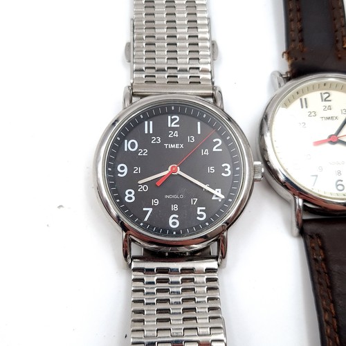 59 - A collection of two Timex Indiglo wrist watches, each featuring associated straps.