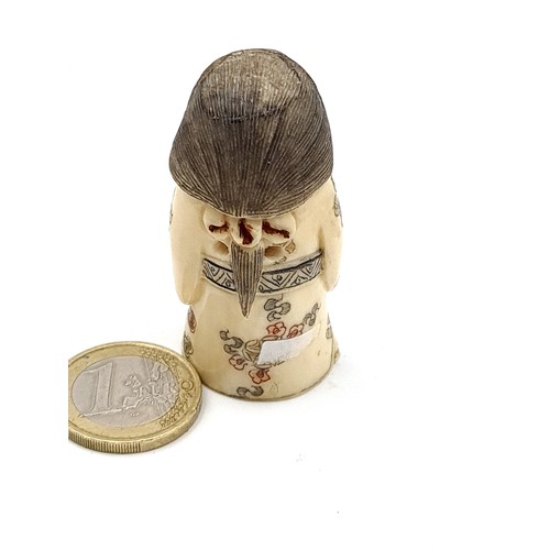 916 - An unusual antique bine Netsuke figure, carved from bone and featuring an Asian lady courtier donned... 