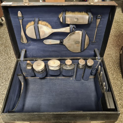 952 - Star Lot: A fabulous antique travel vanity case comprising of sterling silver topped items including... 