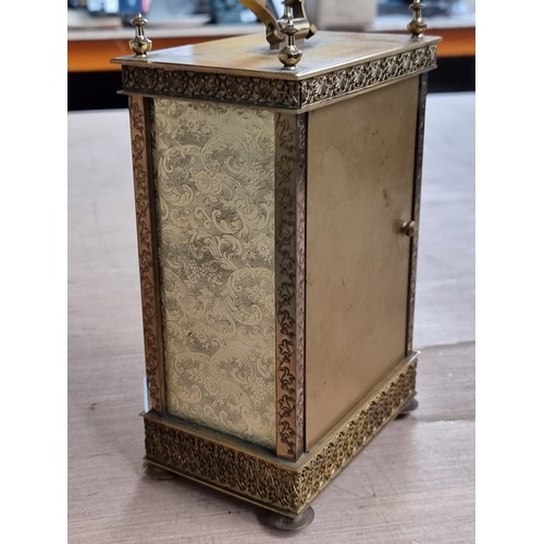 221 - A heavy, good quality and highly ornate carriage clock from London Clock Co. Housed in a brass case ... 