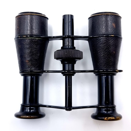 956 - Antique binoculars with a compass to centre. Accompanied by an antique leather case.