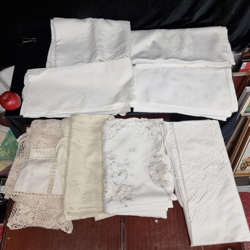 312 - A set of eight vintage linen and lace table cloths in good clean pressed condition.