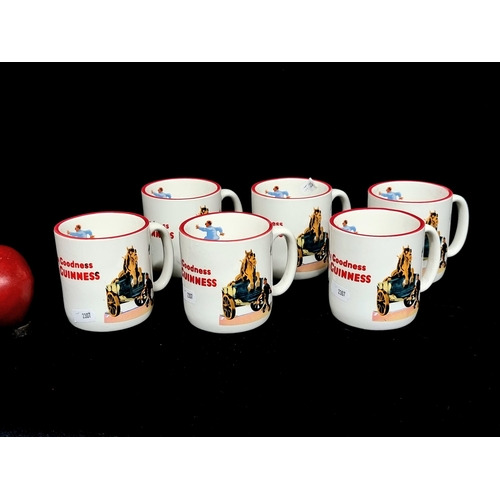 313 - A set of six authentic Guinness branded ceramic mugs / cups with red rims and the iconic Gilroy imag... 